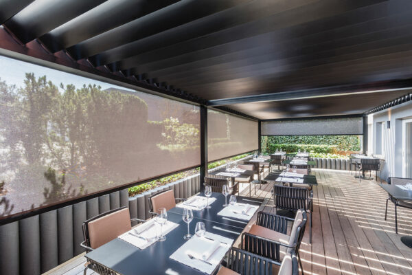 Restaurant patio with motorized roller screens