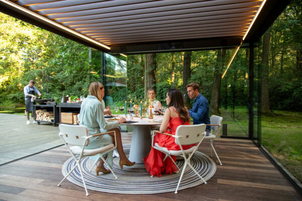 Canadian friends dining under an Aluminum Louvered Pergola